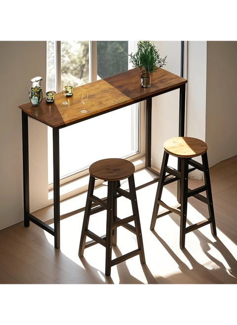 3-piece dining table set, consisting of one high table and two high chairs. It is a high-height kitchen table with seats in a modern and contemporary design and a steel frame. It is placed in the kitchen, dining room, living areas, and social areas. It is a rustic brown color with a black metal frame. It is durable and can be used in the kitchen, living room, dining room, or office. You can use the table as a coffee corner, a work desk, an entrance console, behind the sofa, or as a buffet for appetizers and drinks when needed. The chairs can be used during occasions as additional chairs or as a corner table. In some corners, vases or plant pots can be placed on it. The seat is round and has a soft texture that is not scratched. The chair has comfortable footrests when sitting on it. These details and design touches make you sit more comfortably. Easy to assemble and assemble