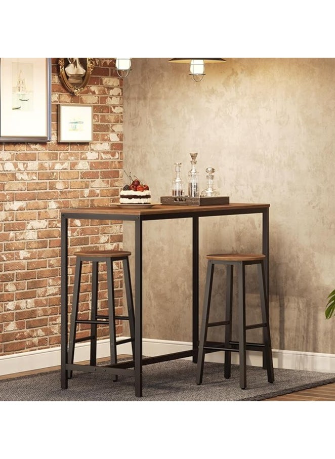 3-piece dining table set, consisting of one high table and two high chairs. It is a high-height kitchen table with seats in a modern and contemporary design and a steel frame. It is placed in the kitchen, dining room, living areas, and social areas. It is a rustic brown color with a black metal frame. It is durable and can be used in the kitchen, living room, dining room, or office. You can use the table as a coffee corner, a work desk, an entrance console, behind the sofa, or as a buffet for appetizers and drinks when needed. The chairs can be used during occasions as additional chairs or as a corner table. In some corners, vases or plant pots can be placed on it. The seat is round and has a soft texture that is not scratched. The chair has comfortable footrests when sitting on it. These details and design touches make you sit more comfortably. Easy to assemble and assemble