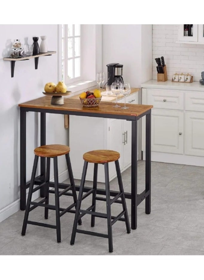 3-piece dining table set, consisting of one high table and two high chairs. It is a high-height kitchen table with seats in a modern and contemporary design and a steel frame. It is placed in the kitchen, dining room, living areas, and social areas. It is a rustic brown color with a black metal frame. It is durable and can be used in the kitchen, living room, dining room, or office. You can use the table as a coffee corner, a work desk, an entrance console, behind the sofa, or as a buffet for appetizers and drinks when needed. The chairs can be used during occasions as additional chairs or as a corner table. In some corners, vases or plant pots can be placed on it. The seat is round and has a soft texture that is not scratched. The chair has comfortable footrests when sitting on it. These details and design touches make you sit more comfortably. Easy to assemble and assemble