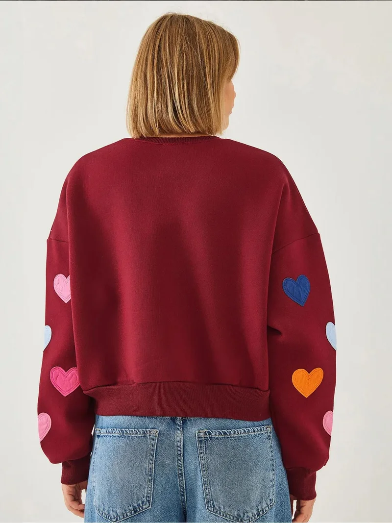 بيانكو لوتشي كنزة قطنية مطرزة بقلوب من لوكسي