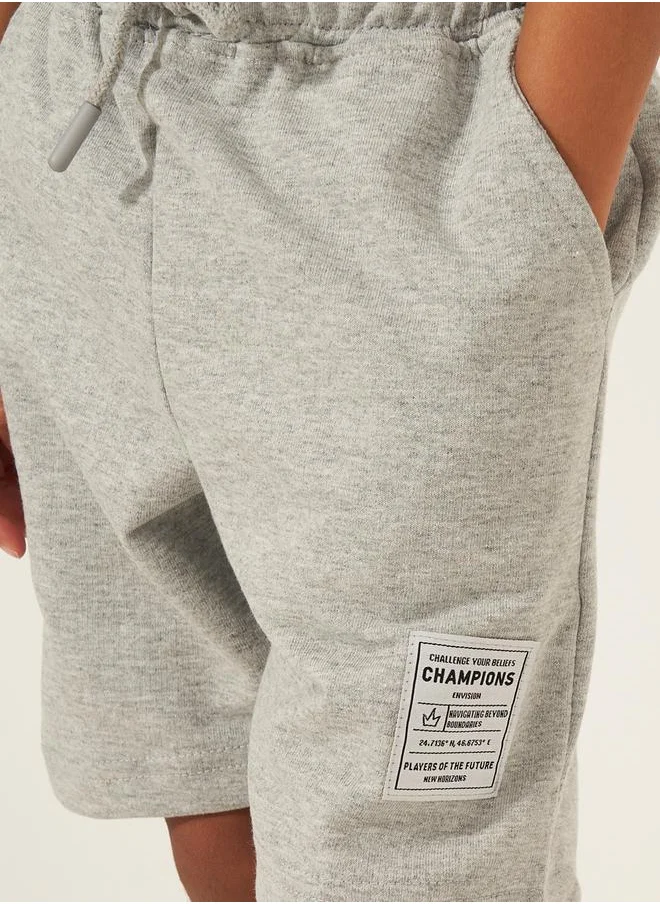 ستايلي Solid Drawstring Shorts with Badge Detail