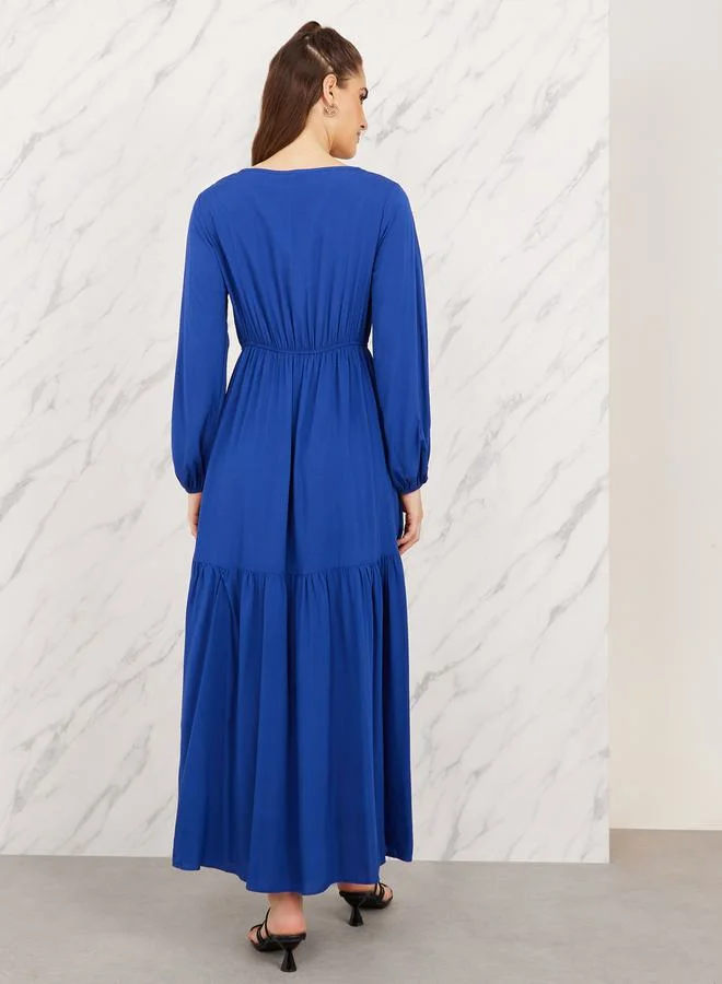 Styli Aztec Printed Tie Up Neck Tiered Maxi Dress