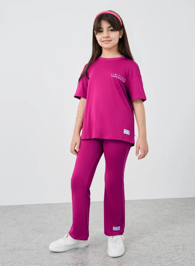 ستايلي Styli Slogan Print Oversized T-Shirt and Flared Leggings Set