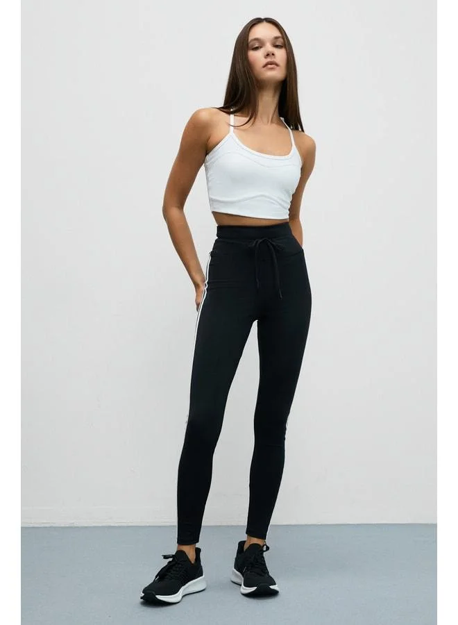 Urban Beat NORGIA Women's Soft and Stretchy Textured Contrast-Piped Drawstring Black-and-White Leggings.