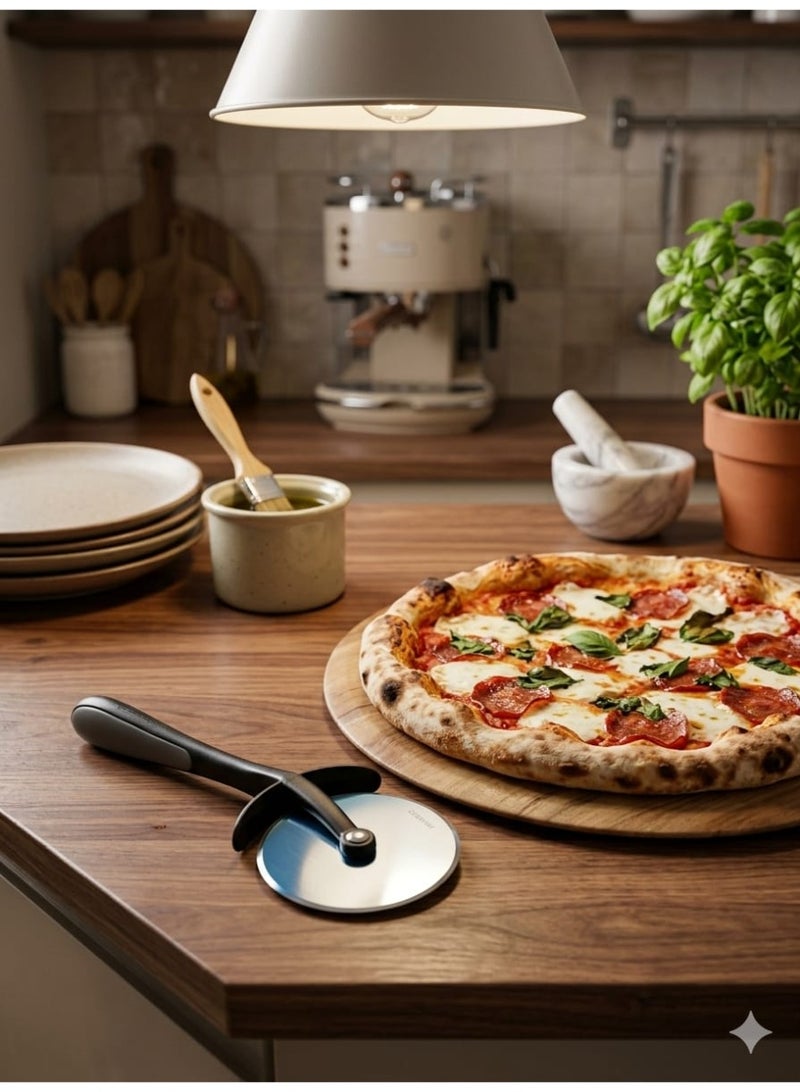 This pizza cutter features a stainless steel wheel design, is sharp and durable, and has a comfortable grip – perfect for cutting pizza, pastries, and dough – and is dishwasher safe. - Image 1