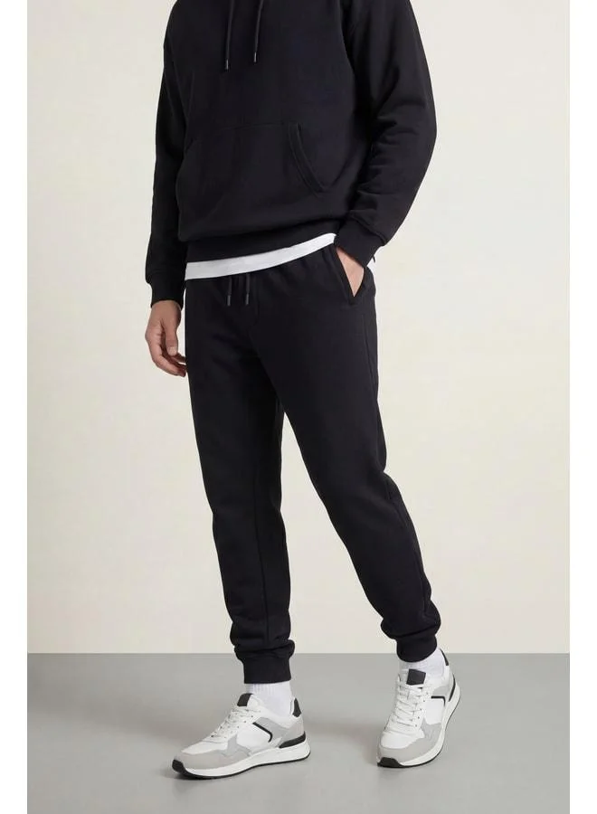 mmetalic Men’s Black Regular Fit Sweatpants with Elastic Cuffs and Detailed Back Pocket Label