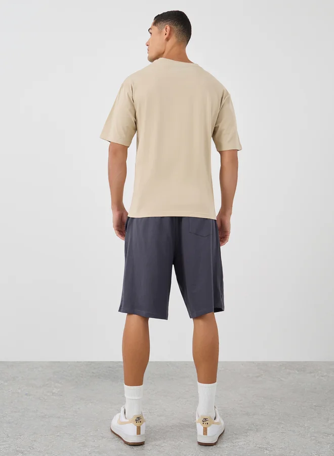 Styli Styli Men Beige Slogan Print Oversized T-Shirt and Shorts Co-Ords