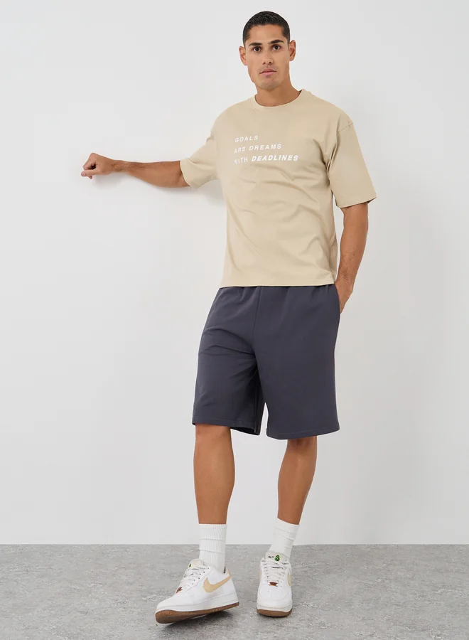 ستايلي Styli Men Beige Slogan Print Oversized T-Shirt and Shorts Co-Ords