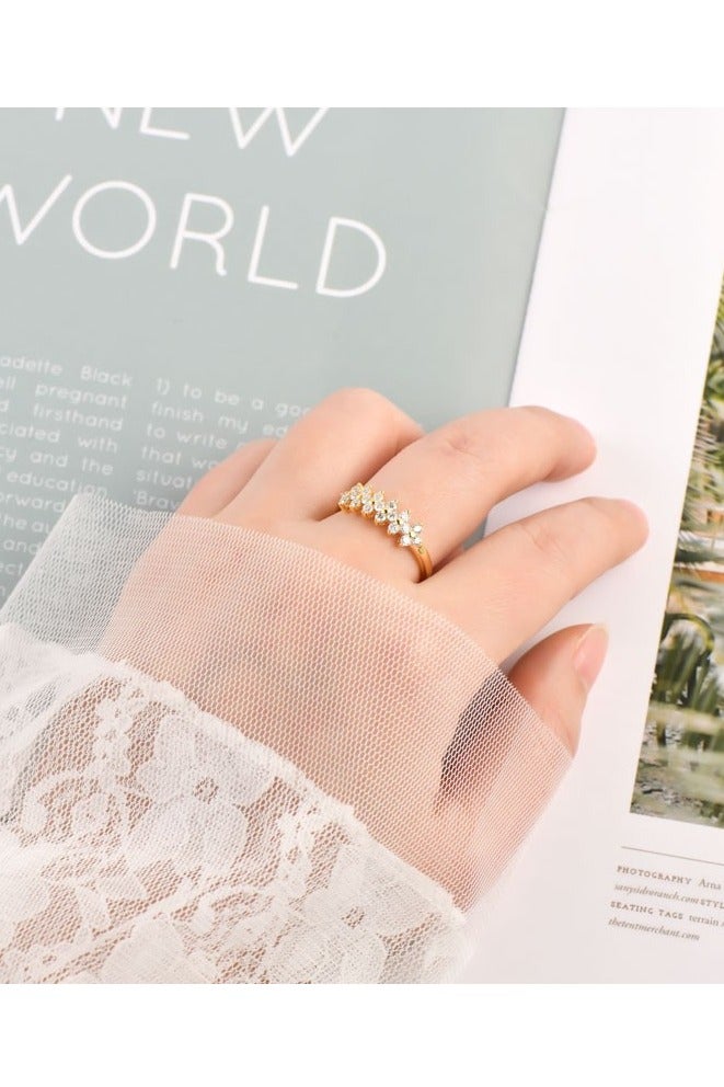 ROMAD Elegant floral-designed rings in gold, rose gold, and silver tones, each featuring a central sparkling stone. - Image 2