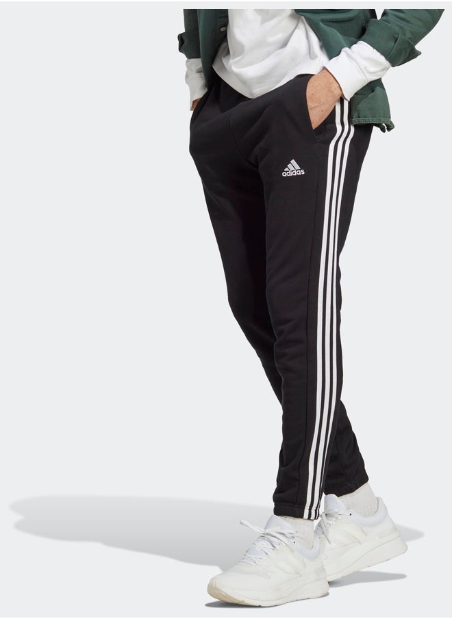 Adidas بنطال رياضي أساسيات فرينش تيري بأساور مطاطية مدببة بثلاثة خطوط  - Image 1