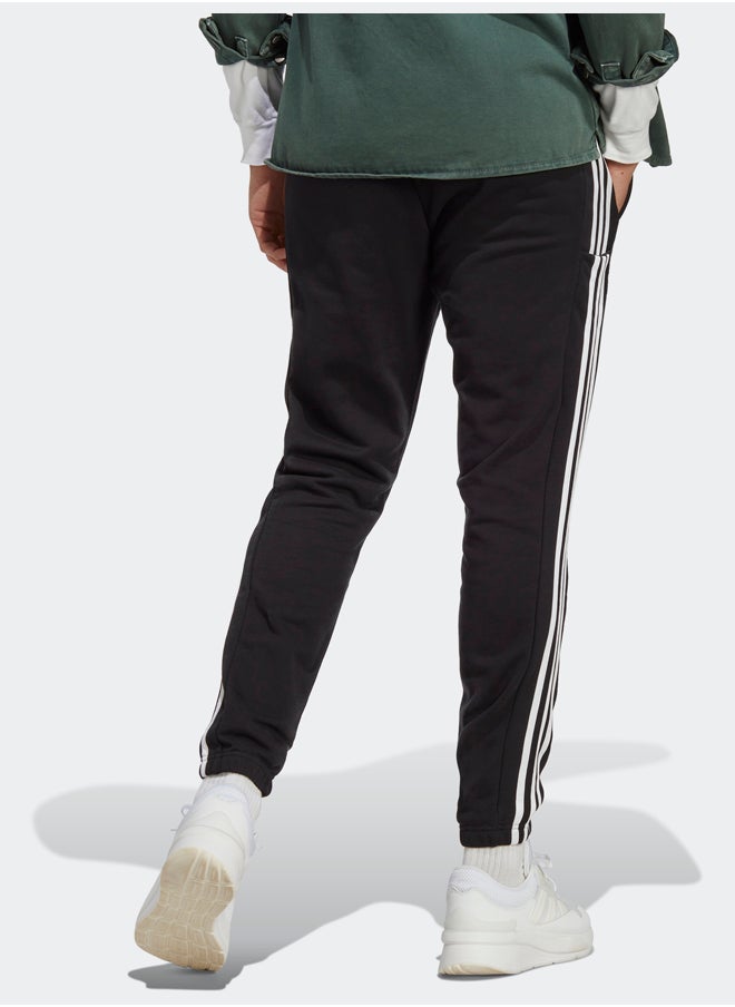 Adidas بنطال رياضي أساسيات فرينش تيري بأساور مطاطية مدببة بثلاثة خطوط  - Image 2