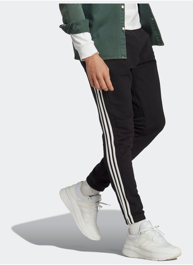 Adidas بنطال رياضي أساسيات فرينش تيري بأساور مطاطية مدببة بثلاثة خطوط  - Image 3