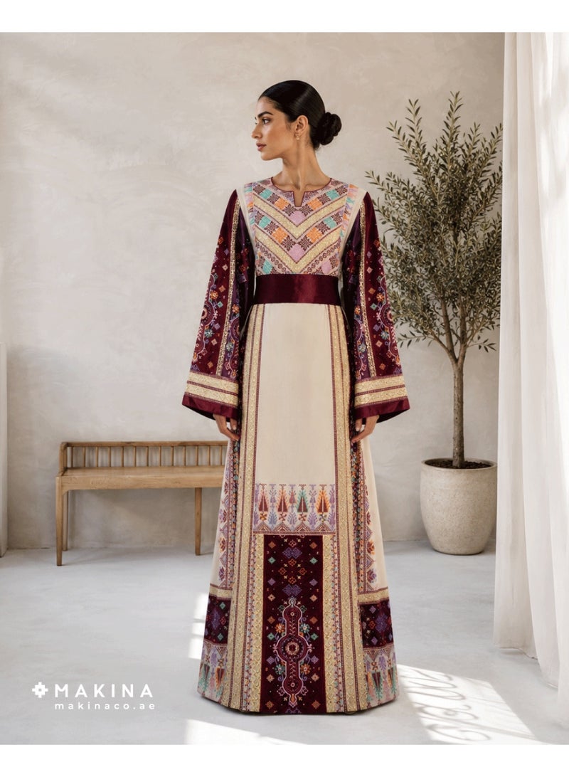 MAKINA A Half-Tallas Fallahi thobe crafted from premium Japanese Mubrad, featuring a rich fusion of Arabian embroidery patterns that reflect deep tradition and intricate artistry. This elegant garment is accented with cool satin for a subtle glow and a luxurious, silky touch. - Image 1
