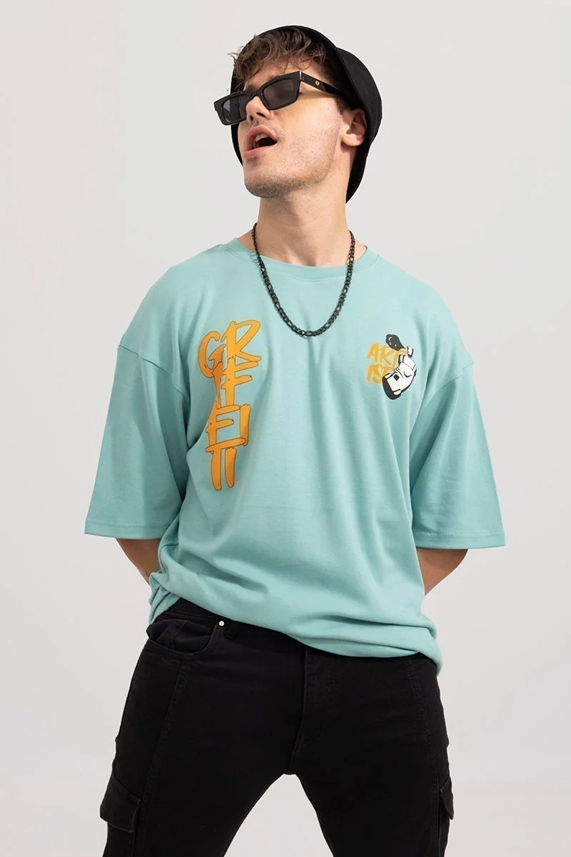 سنيتش تيشيرت واسع بطبعة جرافيتي باللون الأخضر الفيروزي