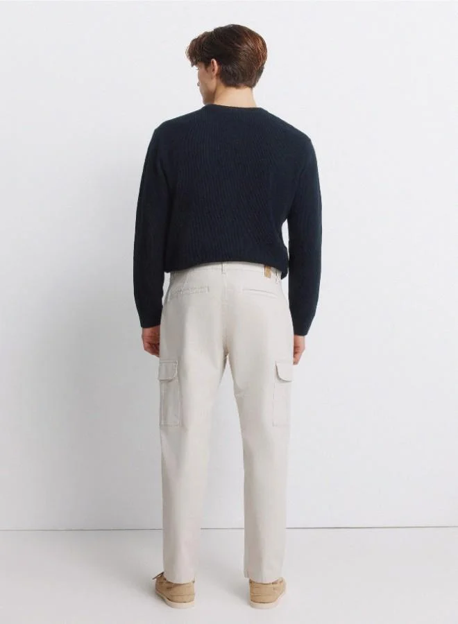 Springfield  Cargo trousers in stretch cotton fabric for greater comfort. Two side pockets on both legs, with flap and hidden button fastening. Comfort slim fit. for Men | Best Price UAE