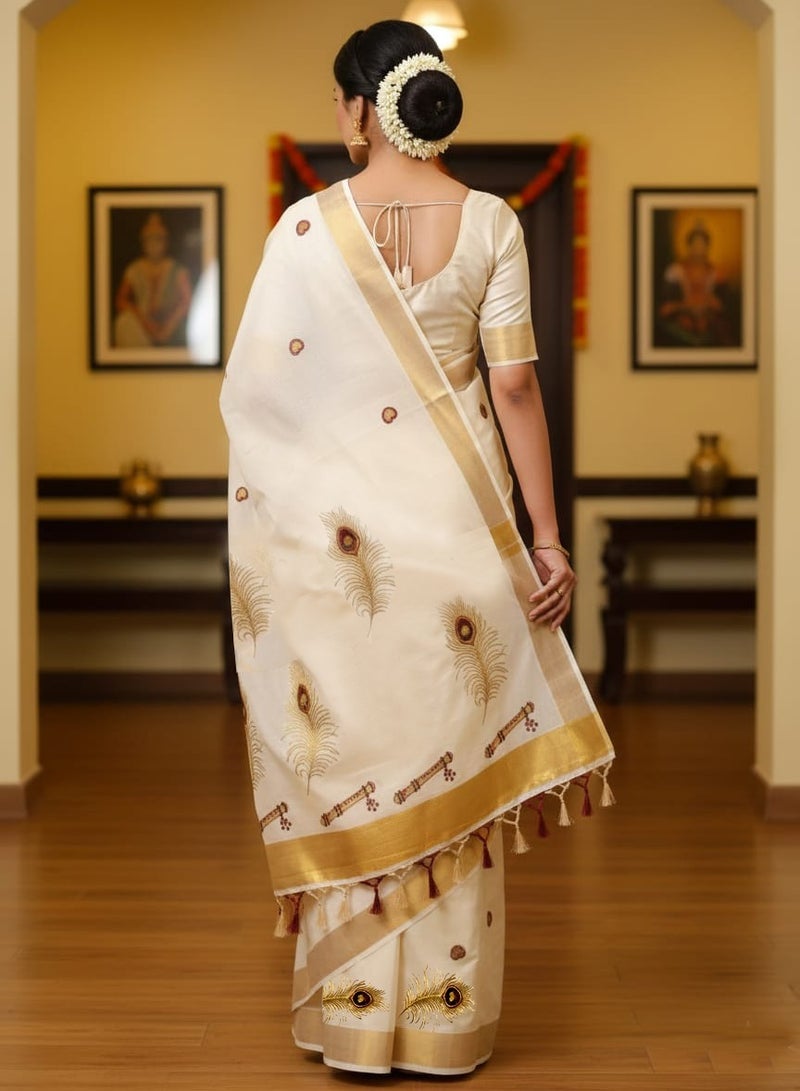 A.M traditional Kerala Kasavu saree. The saree is off-white or cream-colored with significant peacock feather motifs - Image 1