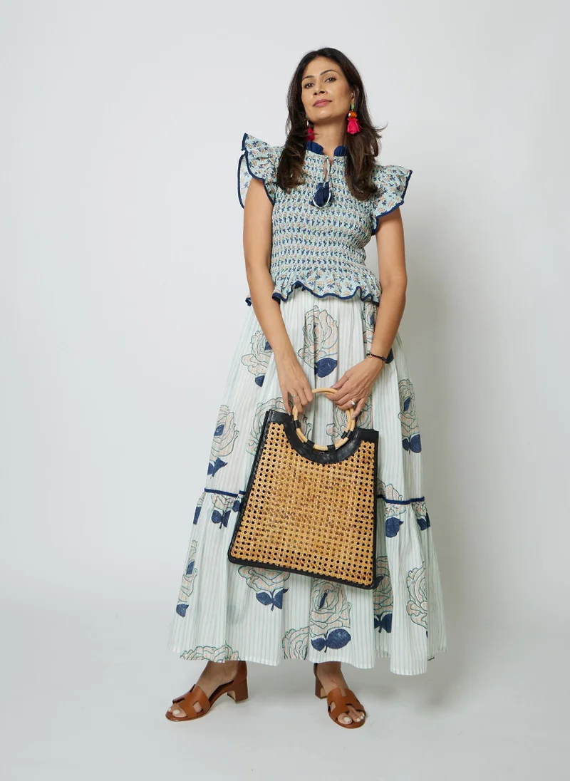 كشمش The MARIS SKIRT DRESS is a clever two-in-one design that mimics the look of a coordinated skirt and top in one elegant piece. This maxi dress features a contrasting collar that adds definition and style, while the smocked body creates a flattering, structured fit. Below, a flowing skirt portion moves freely with you, offering comfort and grace. Practical hidden pockets keep your essentials close. Perfect for effortless styling that looks intentionally put-together.Chest without stretch 26" and 48" with stretch. Length 54"Fits UK 8-14 beautifullyModel wears UK 10 and is 5'6 height.