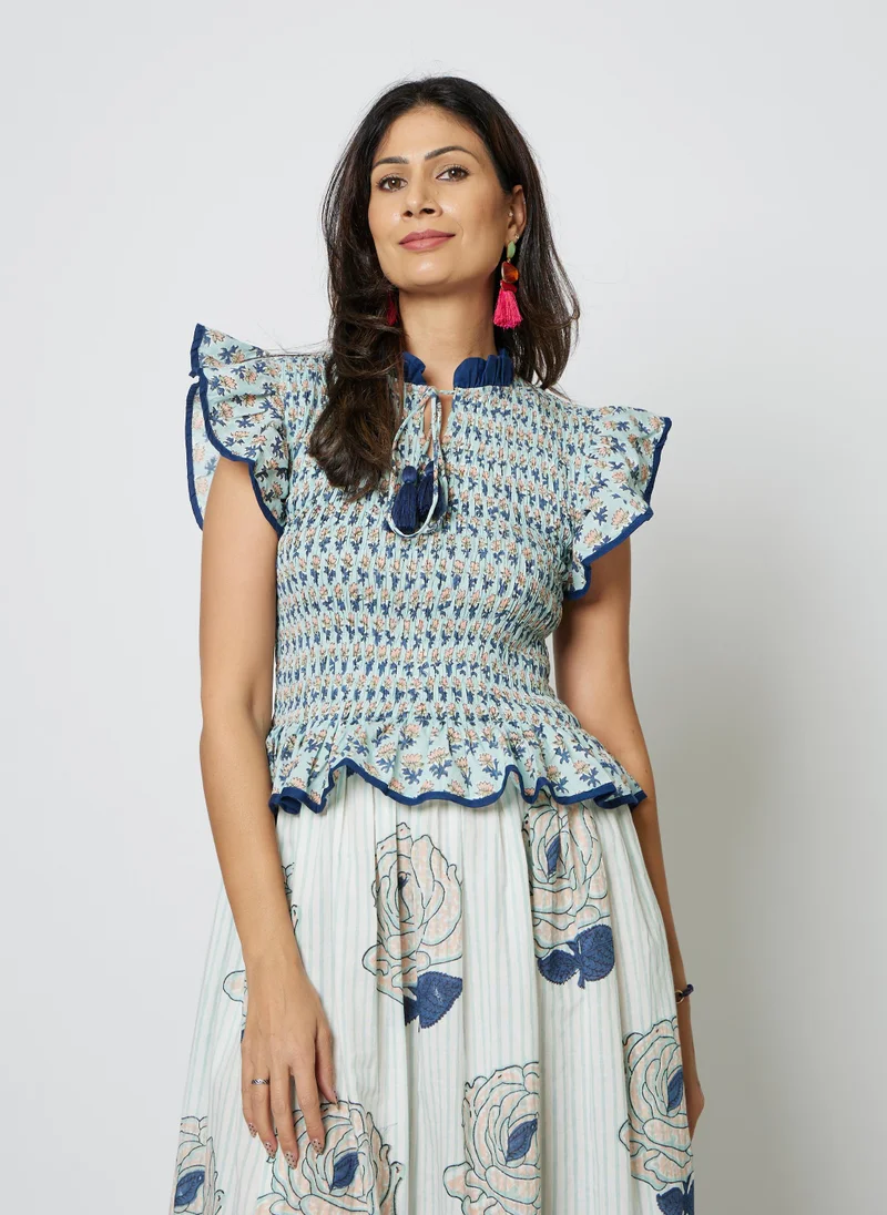 كشمش The MARIS SKIRT DRESS is a clever two-in-one design that mimics the look of a coordinated skirt and top in one elegant piece. This maxi dress features a contrasting collar that adds definition and style, while the smocked body creates a flattering, structured fit. Below, a flowing skirt portion moves freely with you, offering comfort and grace. Practical hidden pockets keep your essentials close. Perfect for effortless styling that looks intentionally put-together.Chest without stretch 26" and 48" with stretch. Length 54"Fits UK 8-14 beautifullyModel wears UK 10 and is 5'6 height.