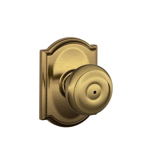 SCHLAGE F40 GEO 609 CAM Camelot Collection Georgian Privacy Knob, Antique Brass - Image 1