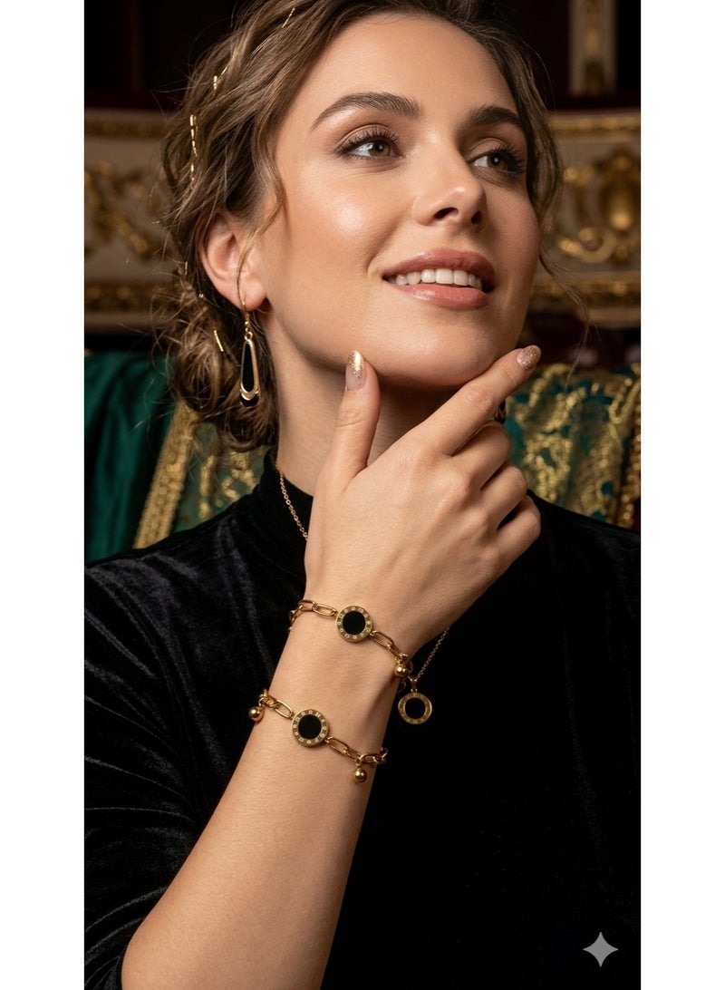 سوار ستانلس ستيل ذهبي بقطع سوداء دائرية للنساء. - Image 1