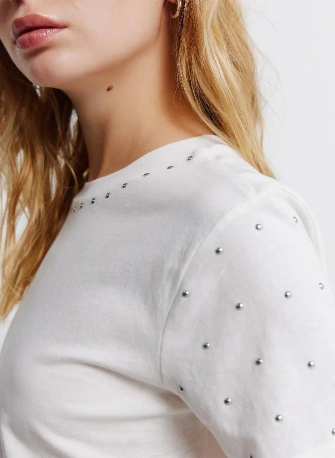 Springfield  Sustainable cotton round neck straight fit short sleeve T-shirt with studs on the neck and sleeves for Women | Best Price UAE
