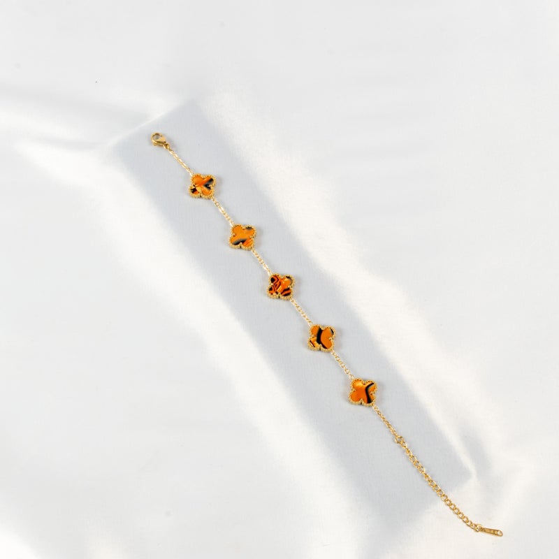 ذا بلاك بيرل اكسسوريز أنسيال أستانليس ستيل ذهبي مع شكل زهرة البرسيم بألوان خلابة - Image 1