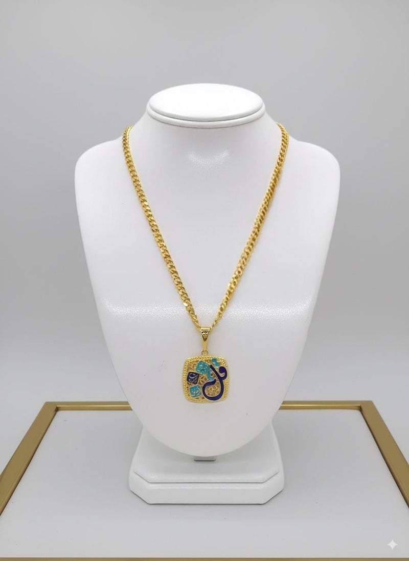 A piece of art that carries a message of reassurance and tranquility in its design. The pendant takes an elegant square shape with rounded edges, decorated with delicate geometric patterns and harmonious shades of gold, blue, and turquoise.

At the heart of the design, the holy verse "Say, I seek refuge in the Lord of the Daybreak" stands out in elegant and attractive Arabic calligraphy. The word "Say" stands out in a larger size and a rich blue hue that steals the spotlight, while the rest of the verse elegantly wraps around it, creating a unique artistic masterpiece.

Dangling from a thick gold chain, this pendant makes for a distinctive and eye-catching piece that adds a touch of elegance and spirituality to any look. - Image 3