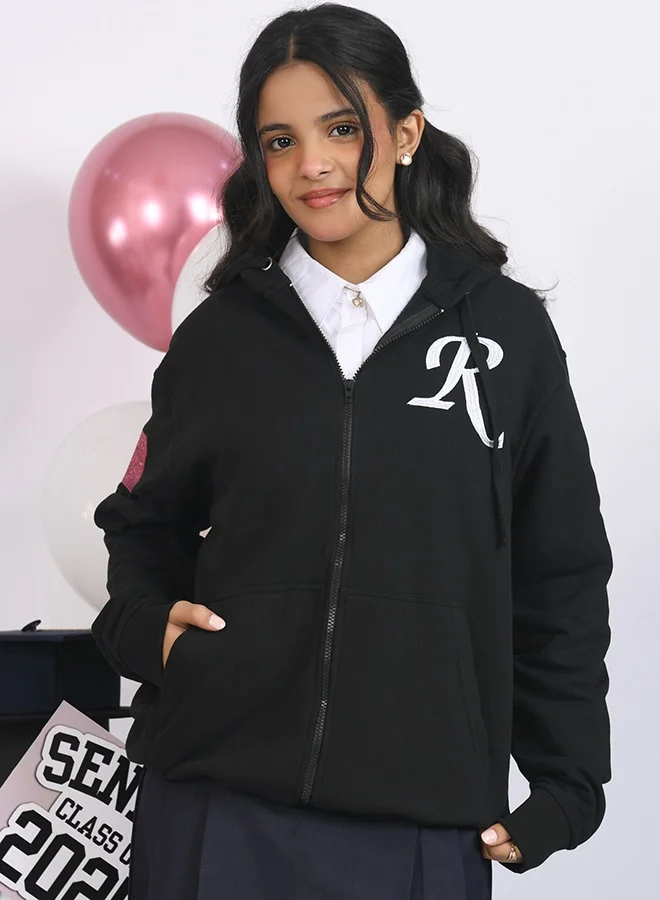 HAWRAA ABAYA Black graduation hoodie with custom embroidery.