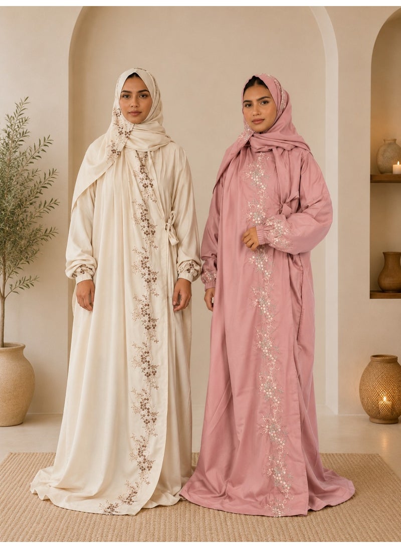 A two-piece women's prayer set featuring elegant embroidery and soft, comfortable fabric; it includes an attached head covering and a loose-fitting design that provides full coverage during prayer.
