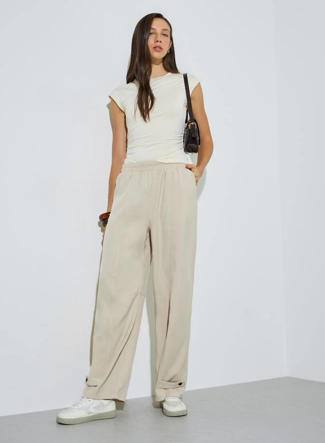 ستايلي Beige Relaxed Fit Pants with Ankle Buttons