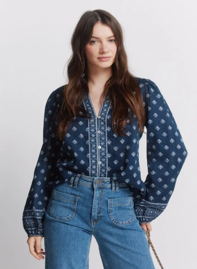 سبرينجفيلد قميص طويل الأكمام مطبوعة وضخم. ياقة دائرية مع فتحة على شكل V. الأزرار الأمامية. أصفاد مطاطية. هذا القطعة مصنوعة من القطن المستدام بنسبة 100٪.