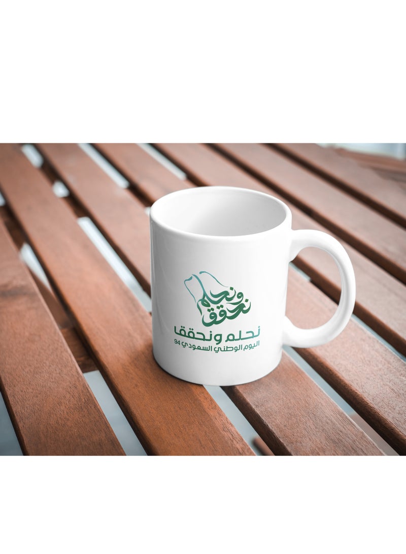 حكاية شمعة مج من السيراميك بطبعة تصميم "شعار اليوم الوطني 94" بلون أبيض - Image 3