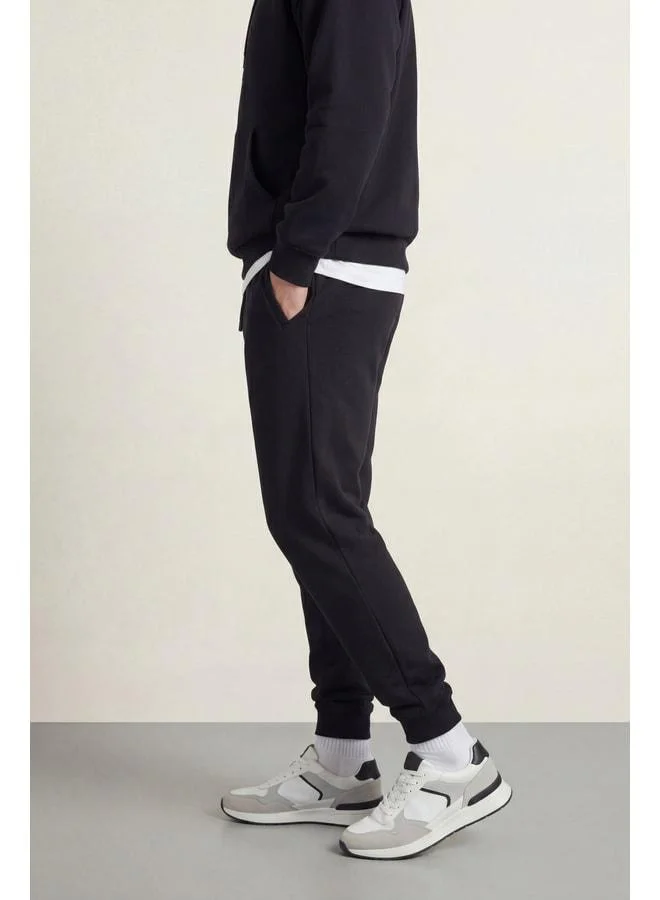 Mmetalic  Men’s Black Regular Fit Sweatpants with Elastic Cuffs and Detailed Back Pocket Label for Men | Best Price UAE