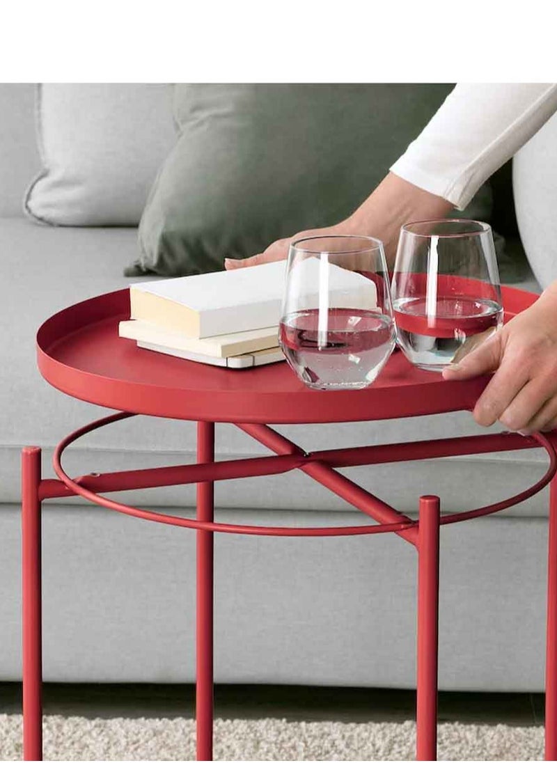 Red metal table in the form of a circular tray