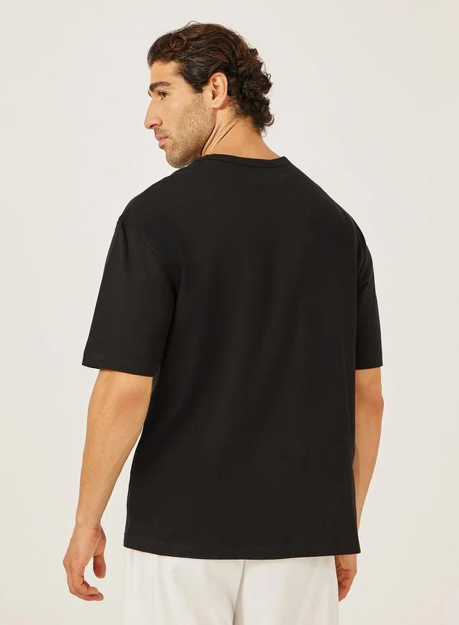 Styli Styli Placement Embroidered Oversized Henley Neck T-Shirt