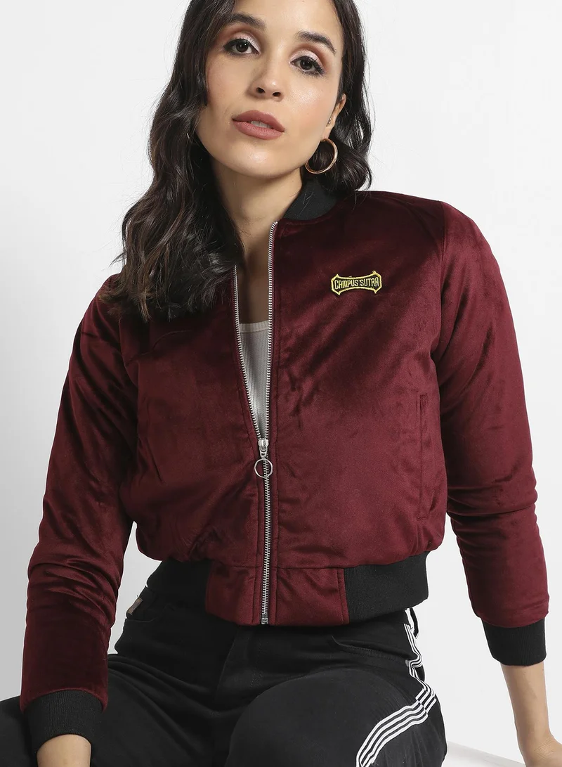 Campus Sutra Women's Maroon Velvet Bomber Jacket With Ribbed Hem For Casual Wear | Low Stand-Up Collar | Long Sleeve | Zipper Closure | Velvet Jacket Crafted With Comfort Fit For Everyday Wear