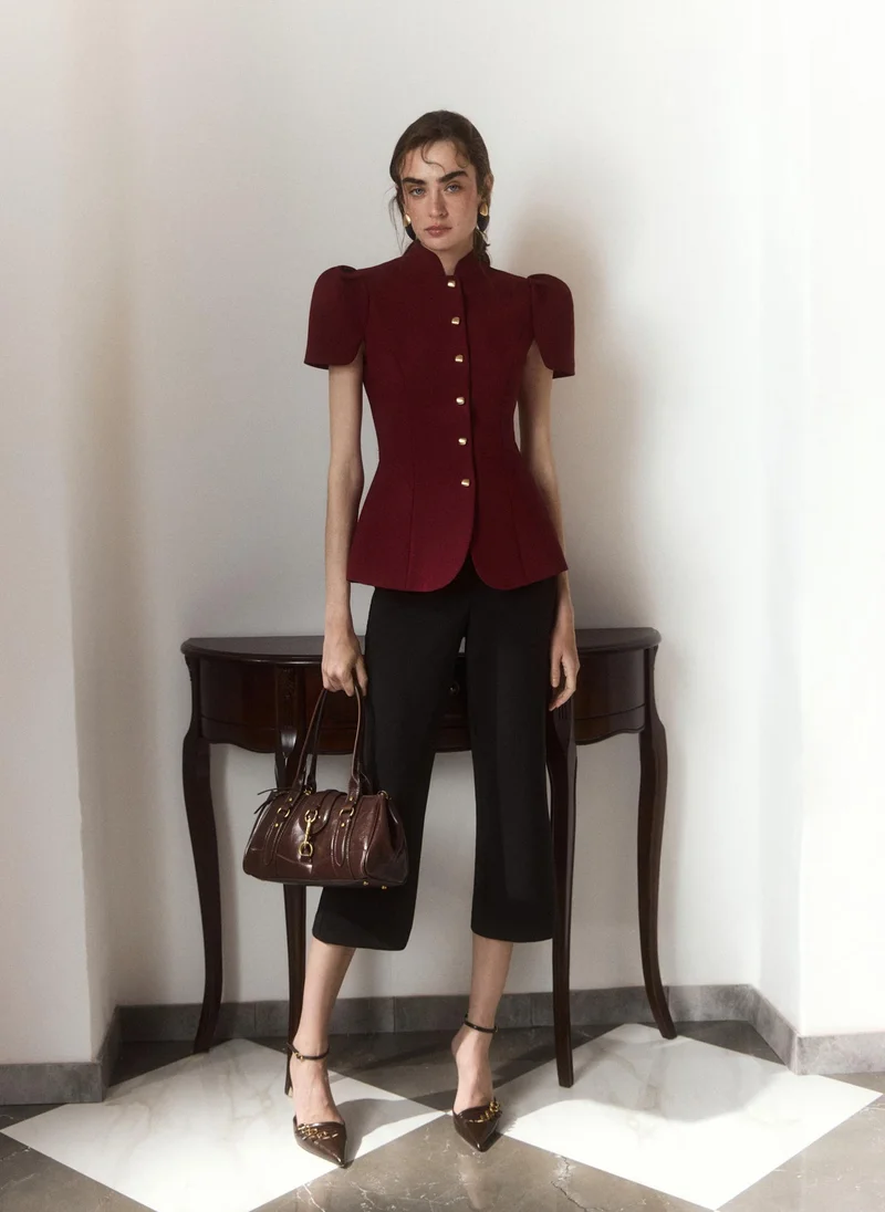 Fitted jacket with a stand-up collar and voluminous sleeves