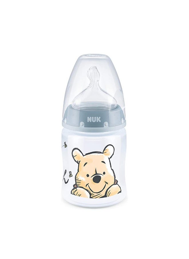 نوك رضاعة نيوك فيرست تشويس بلس (إصدار ديزني) من البلاستيك عالي الجودة - 150 مل (رأس سيليكون مقاس M)Disney Design: Features charming Disney characters (Winnie the Pooh), adding a playful touch to feeding time. - Image 1