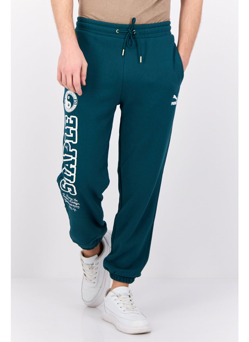 Puma x Staple Men Sportswear Fit Outdoor Sweatpant, Green  - Image 1
