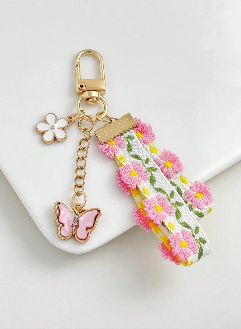 سلسلة مفاتيح بتصميم الدانتيل والزهور مع فراشه باللون الوردي - Image 1