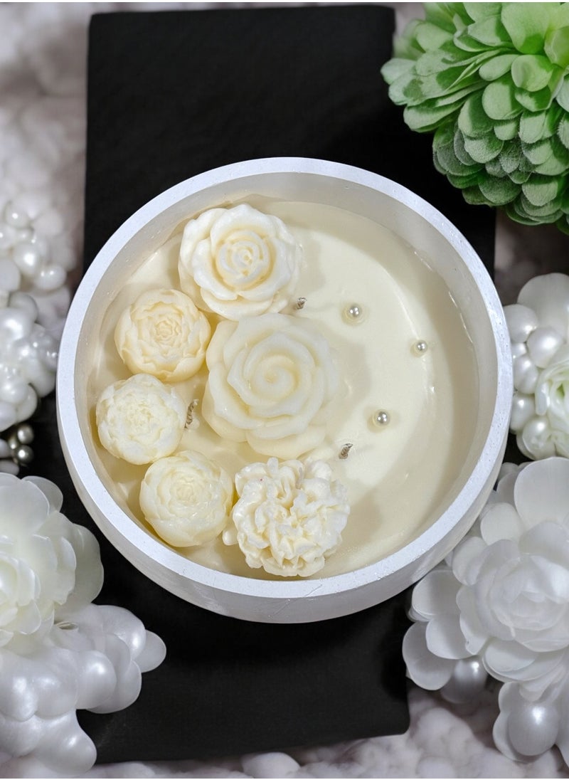 Scented candle with phrases decorated with wax roses in a long circular gypsum plate