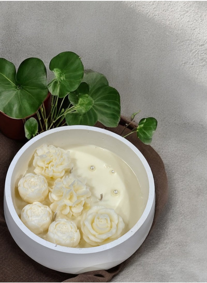 Scented candle with phrases decorated with wax roses in a long circular gypsum plate