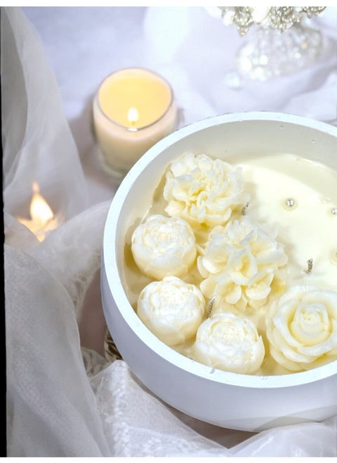 Scented candle with phrases decorated with wax roses in a long circular gypsum plate