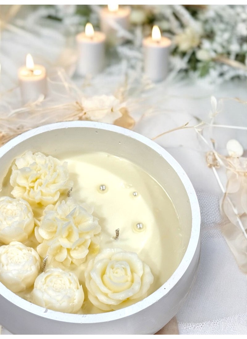 Scented candle with phrases decorated with wax roses in a long circular gypsum plate