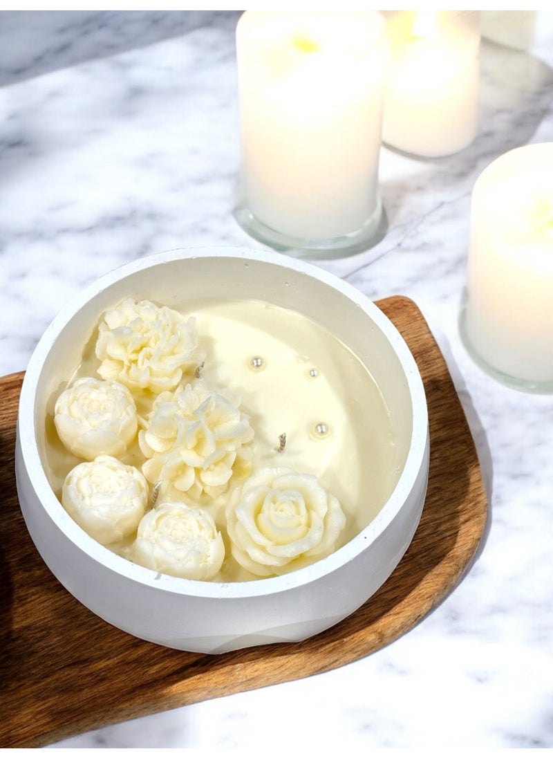 Scented candle with phrases decorated with wax roses in a long circular gypsum plate