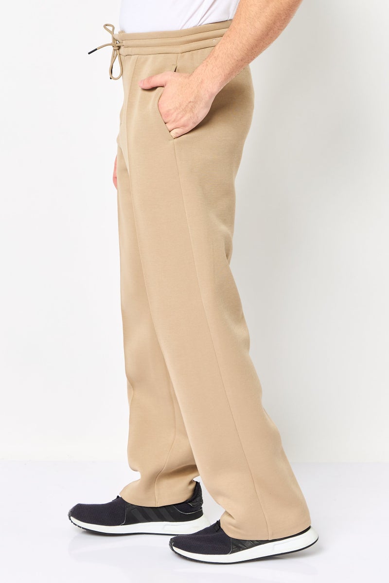 Nike سروال رياضي خارجي فضفاض للرجال، مستقيم الساق، تان - Image 3