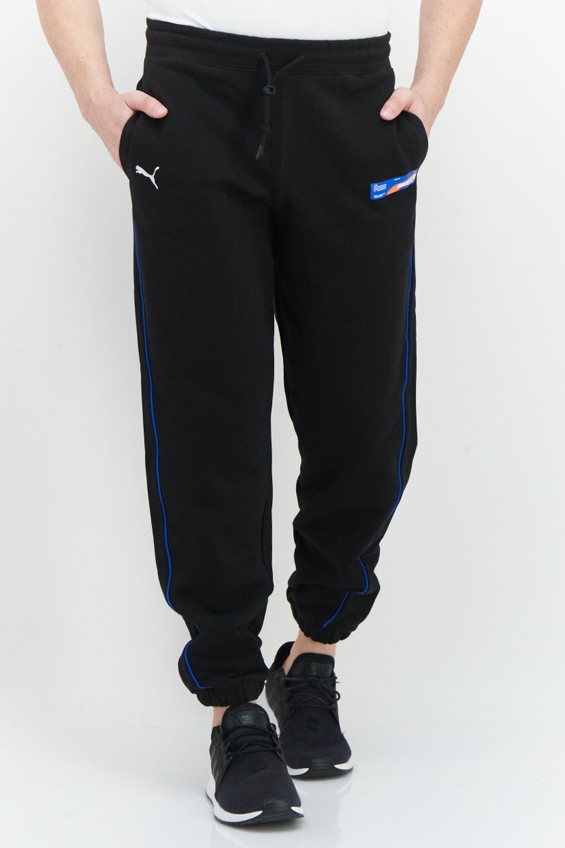 PUMA Roaringwild x Puma Men Sportswear Fit Brand Logo Training Sweatpants, Black - Image 1