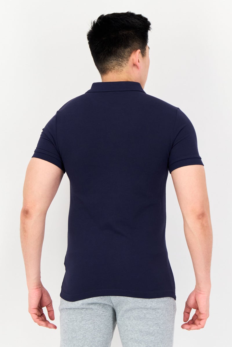 PUMA قميص بولو قصير الأكمام للرجال من One8 بتصميم ضيق مع شعار العلامة التجارية، أزرق داكن - Image 4