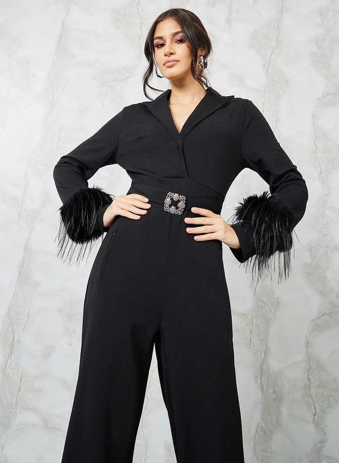 Styli Faux Feather Textured Knit Jumpsuit with Embellished Buckle