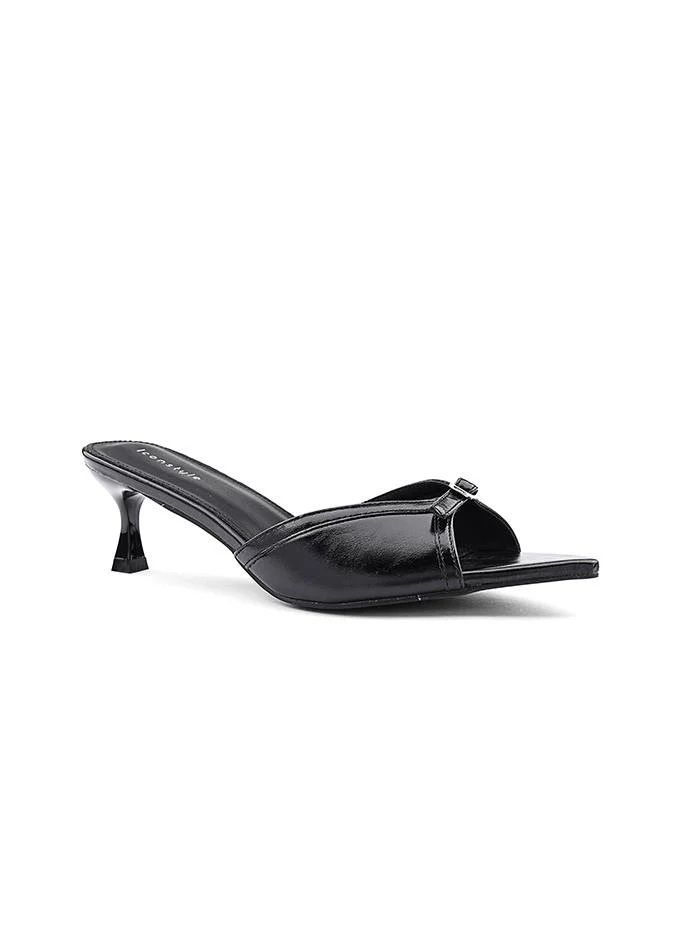 أيقون Feminine slipper featuring a satin texture and bow.